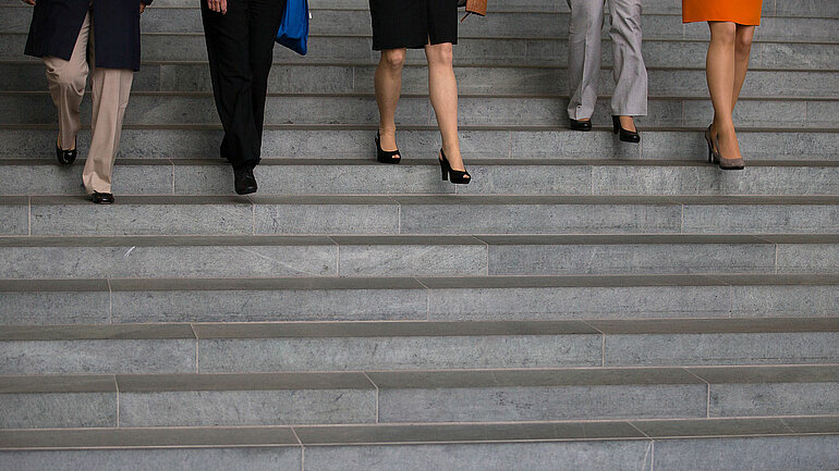 Frauen gehen eine Treppe herunter